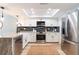 Bright kitchen featuring stainless steel appliances, white cabinets, a skylight, and a stylish countertop at 14700 Seminole Trl, Seminole, FL 33776