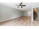 Clean living room with stairs and door, plus modern ceiling fan at 14700 Seminole Trl, Seminole, FL 33776