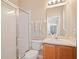 Modern bathroom with a glass-enclosed shower, light wood vanity, and a large mirror that enhances the space at 1604 Harvest Grove Ct, Valrico, FL 33596