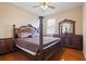 The bedroom features wood floors, a ceiling fan, and dark wood furniture at 1604 Harvest Grove Ct, Valrico, FL 33596