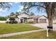 Beautiful home with mature landscaping, a three-car garage and brick paver driveway at 1604 Harvest Grove Ct, Valrico, FL 33596