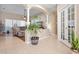 Inviting foyer with tile flooring, decorative columns, and a view into the living room at 1604 Harvest Grove Ct, Valrico, FL 33596