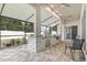 Covered outdoor kitchen with stainless steel grill, stone countertop, and ample seating at 1604 Harvest Grove Ct, Valrico, FL 33596