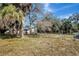 A partial fence runs along the back of the property surrounded by mature landscaping at 16106 Blackbeard Ln, Hudson, FL 34667