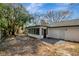 Exterior view of a screened in porch and patio area attached to this home at 16106 Blackbeard Ln, Hudson, FL 34667