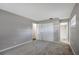 Bedroom with neutral color palette, carpet, window, and an ensuite bathroom entry at 16106 Blackbeard Ln, Hudson, FL 34667