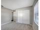 Neutral bedroom featuring carpeted floors and a closet for storage at 16106 Blackbeard Ln, Hudson, FL 34667