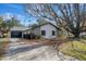 Charming home featuring stone accents, a well-maintained yard, and a spacious driveway at 16106 Blackbeard Ln, Hudson, FL 34667