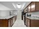 Bright kitchen featuring granite counters, stainless steel appliances, and wood cabinetry at 16106 Blackbeard Ln, Hudson, FL 34667