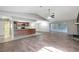 Open concept living room featuring wood floors and access to the updated kitchen at 16106 Blackbeard Ln, Hudson, FL 34667