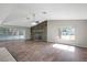 Bright living room features a stone fireplace, ceiling fan, and sliding glass doors at 16106 Blackbeard Ln, Hudson, FL 34667