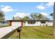 Charming single-story home featuring a well-manicured lawn and a freshly painted exterior at 1624 Barry Rd, Clearwater, FL 33756