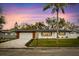 Charming single-story home featuring a well-manicured lawn and a vibrant sky at dusk at 1624 Barry Rd, Clearwater, FL 33756