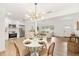 Stylish dining room featuring a modern chandelier and an open layout to the updated kitchen and living space at 1624 Barry Rd, Clearwater, FL 33756