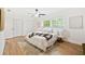 Neutral main bedroom with a ceiling fan, warm natural lighting, and an ensuite at 1624 Barry Rd, Clearwater, FL 33756