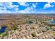 Aerial view of a property with a community featuring nearby lakes and wooded conservation areas at 19131 Weymouth Dr, Land O Lakes, FL 34638