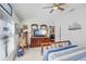 Bright bedroom featuring ceiling fan, dresser with TV, and matching furniture at 19131 Weymouth Dr, Land O Lakes, FL 34638