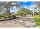 Gated community entrance with lush landscaping at 19131 Weymouth Dr, Land O Lakes, FL 34638