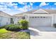 Light and airy single-story home featuring an attached two-car garage and well-maintained landscaping at 19131 Weymouth Dr, Land O Lakes, FL 34638