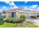 Charming single-story home featuring a blue front door, well-manicured lawn, and attached two-car garage at 19131 Weymouth Dr, Land O Lakes, FL 34638