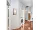 Bright hallway with wood flooring, white walls, and decorative art, offering a clean, inviting transition at 19131 Weymouth Dr, Land O Lakes, FL 34638