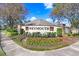 Weymouth community signage with manicured landscaping and seasonal flowers at 19131 Weymouth Dr, Land O Lakes, FL 34638