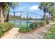 Fenced in community tennis court with landscaping, near walking path at 19131 Weymouth Dr, Land O Lakes, FL 34638