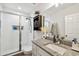 Bathroom featuring a tiled shower, granite vanity, and updated fixtures at 2024 E Columbus Dr, Tampa, FL 33605