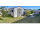 Backyard includes a shed, grassy lawn, and a garden with stone path under a clear blue sky at 2112 Purple Orchid Pl, Ruskin, FL 33570