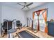 Bright exercise room with a ceiling fan, a window with natural light, and workout equipment at 2112 Purple Orchid Pl, Ruskin, FL 33570