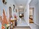 Inviting hallway featuring tile flooring, decorative accents, and access to various rooms in the home at 2112 Purple Orchid Pl, Ruskin, FL 33570