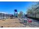 Community playground with slide, monkey bars, spring rider, and wood chip ground cover enclosed by fence at 2112 Purple Orchid Pl, Ruskin, FL 33570