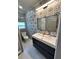 Bathroom featuring stylish mosaic wall, modern double vanity, hexagonal tile flooring, and sleek lighting at 2301 46Th S St, St Petersburg, FL 33711