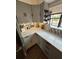 Modern kitchen featuring gray cabinetry, white countertops, and a stylish backsplash at 2301 46Th S St, St Petersburg, FL 33711