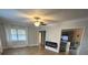 Living room with fireplace and kitchen view, hardwood floors, and neutral paint at 2301 46Th S St, St Petersburg, FL 33711