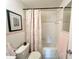 Cozy bathroom features charming pink tile accents and a tub with shower at 2434 Australia E Way # 44, Clearwater, FL 33763