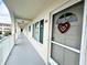 Exterior hallway features smooth flooring, arched supports, and views of the community at 2434 Australia E Way # 44, Clearwater, FL 33763