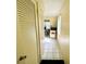 Neutral hallway with a closet, tile flooring, and view into the living spaces at 2434 Australia E Way # 44, Clearwater, FL 33763