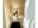 Bright hallway with tile flooring, louvered closet, and a view into the living area at 2434 Australia E Way # 44, Clearwater, FL 33763