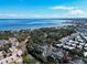 Beautiful aerial view of the community with blue skies and waterfront views of the coast at 2612 Pearce Dr # 210, Clearwater, FL 33764