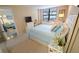 Bedroom with plush carpeting, natural lighting, and decor with bright hues at 2612 Pearce Dr # 210, Clearwater, FL 33764