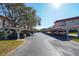 Assigned covered parking spots with mature trees and lush landscaping at 2612 Pearce Dr # 210, Clearwater, FL 33764