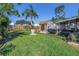 Spacious backyard with lush green grass, a storage shed, a barbecue grill, and a covered patio for outdoor gatherings at 2885 18Th N Ave, St Petersburg, FL 33713