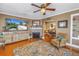 Inviting living room with hardwood floors, brick fireplace, and an open layout to the dining area at 2885 18Th N Ave, St Petersburg, FL 33713