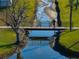 Scenic view of a pedestrian bridge, connecting the community, with a clear water reflection at 36806 Niles Dr, Zephyrhills, FL 33542