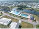 Aerial view of the community pool with a spacious deck, surrounded by lush greenery and landscaping at 36806 Niles Dr, Zephyrhills, FL 33542