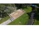 An aerial view of a bocce court showcasing its surroundings with benches at 36806 Niles Dr, Zephyrhills, FL 33542