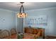 Dining room with wooden table and chairs, a hutch and bird artwork on the wall at 36806 Niles Dr, Zephyrhills, FL 33542