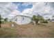 Exterior of a single-story home with a palm tree and well maintained lawn at 36806 Niles Dr, Zephyrhills, FL 33542