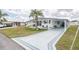 Lovely home with a spacious driveway, covered carport, and inviting front porch, perfect for relaxation at 36806 Niles Dr, Zephyrhills, FL 33542